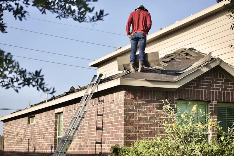 Professional roofer working on a residential roof in DeSoto